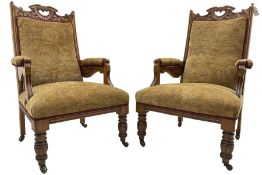 Pair of late Victorian oak salon open armchairs
