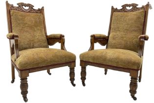 Pair of late Victorian oak salon open armchairs