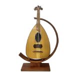 20th century Middle Eastern six string lute with a segmented back and a purpose designed hardwood st
