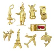 Nine 14ct gold pendant / charms including poodle dog
