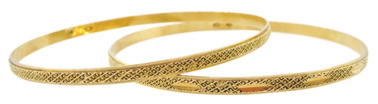 Two Middle Eastern 18ct gold bangles