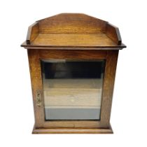 Edwardian oak smokers cabinet with the single glazed door to fitted interior having a single draw an