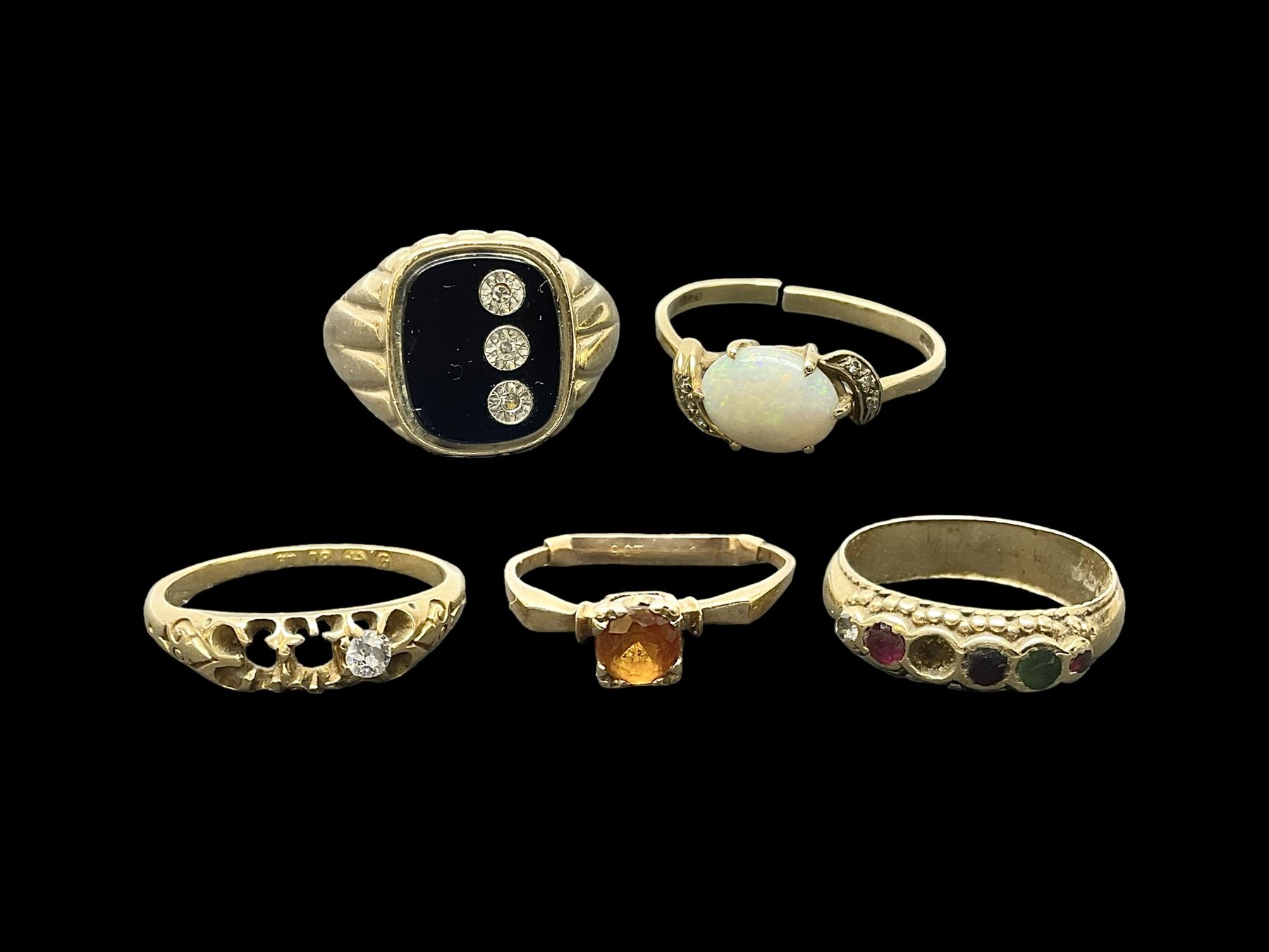 Five gold stone set rings