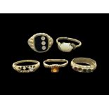 Five gold stone set rings