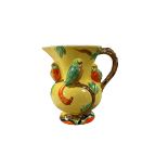 Hand painted jug decorated in relief with parrots on a yellow ground H17cm