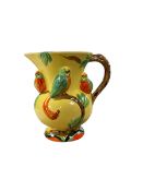 Hand painted jug decorated in relief with parrots on a yellow ground H17cm