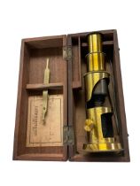 Small brass students microscope in a mahogany fitted box