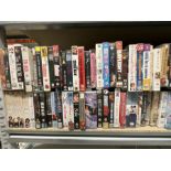 Two bays of vintage VHS videos