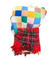 Multicoloured knitted patchwork blanket and a tartan blanket