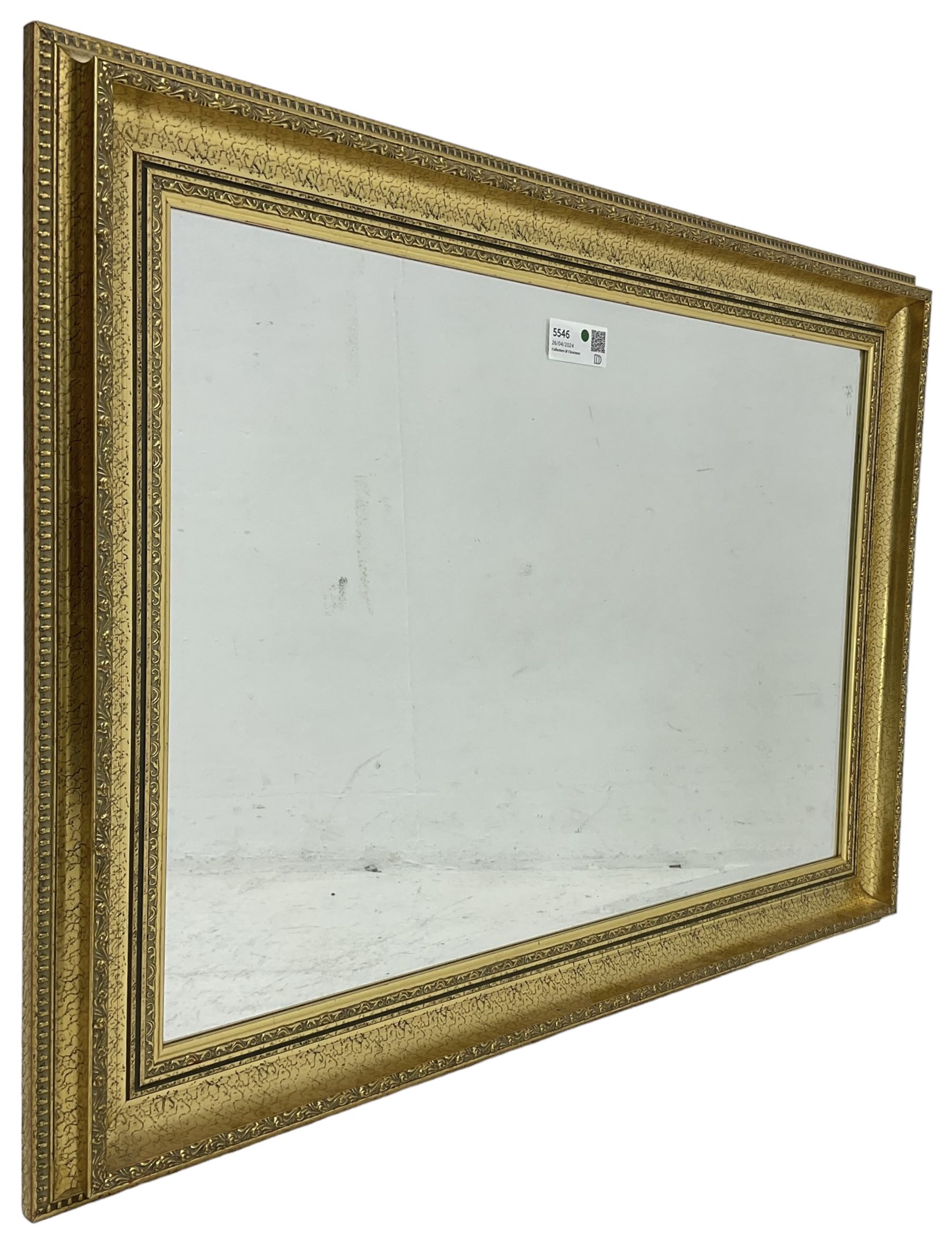 Gilt framed wall mirror with bevelled plate (91cm x 65cm); pair of ladder back carver armchairs (W52