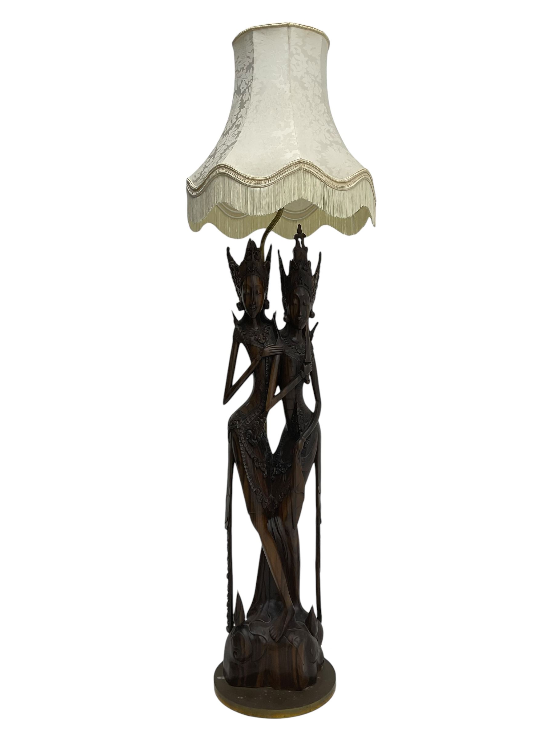 Carved hardwood figural standard lamp