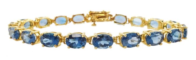 Gold oval cut London blue topaz link bracelet