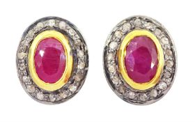 Pair of silver and silver-gilt oval cut ruby and diamond cluster stud earrings
