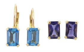 Pair of gold tanzanite stud earrings and a pair of gold blue topaz pendant earrings
