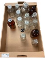 Collection of glass chemical bottles including amber glass examples