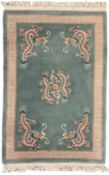 Chinese jade ground woollen rug decorated with dragons
