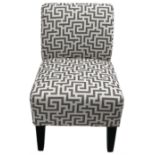 Bedroom chair upholstered in geometric fabric on black finish supports