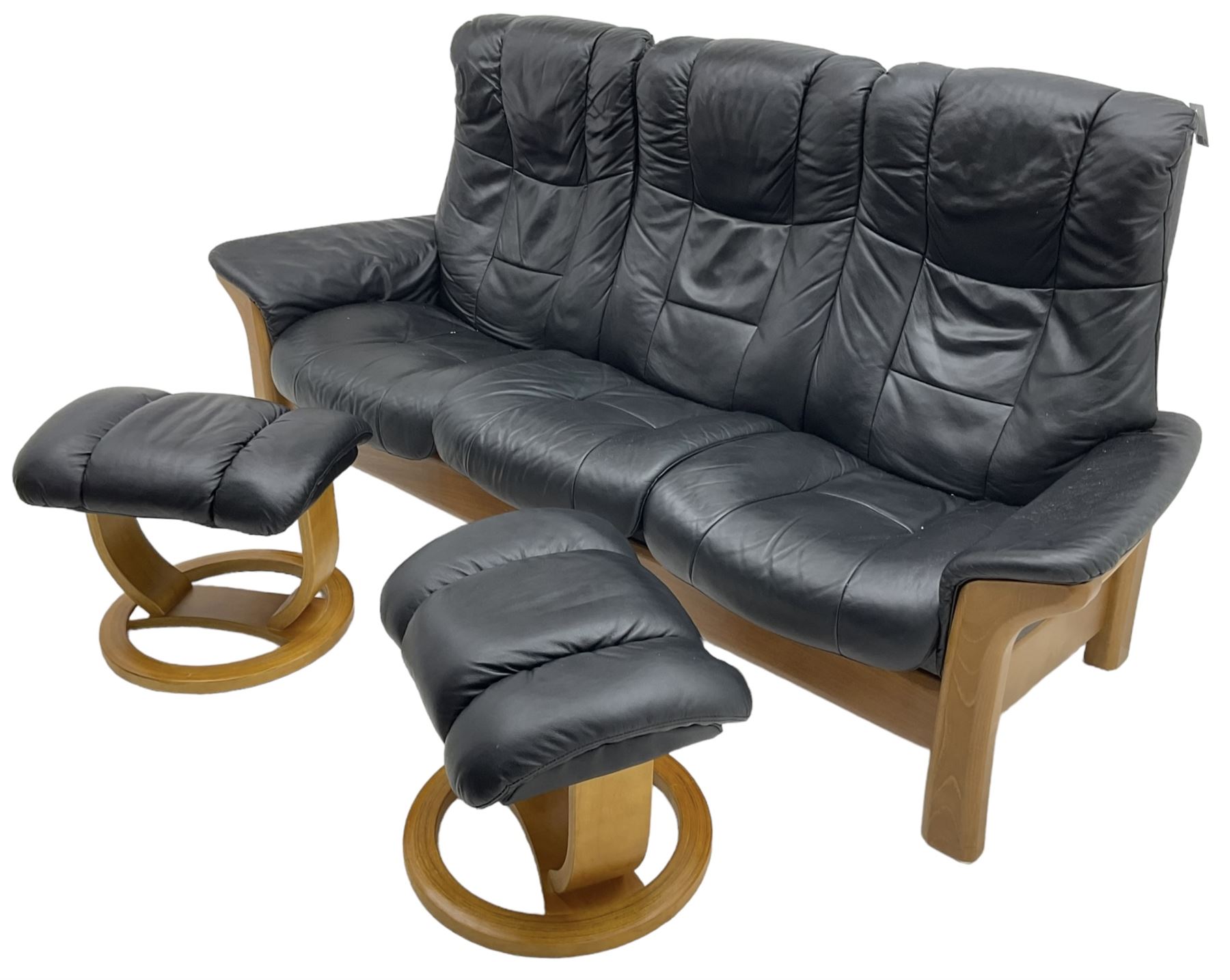 Stressless - 'Buckingham' three-seat settee upholstered in black leather; together with two associat