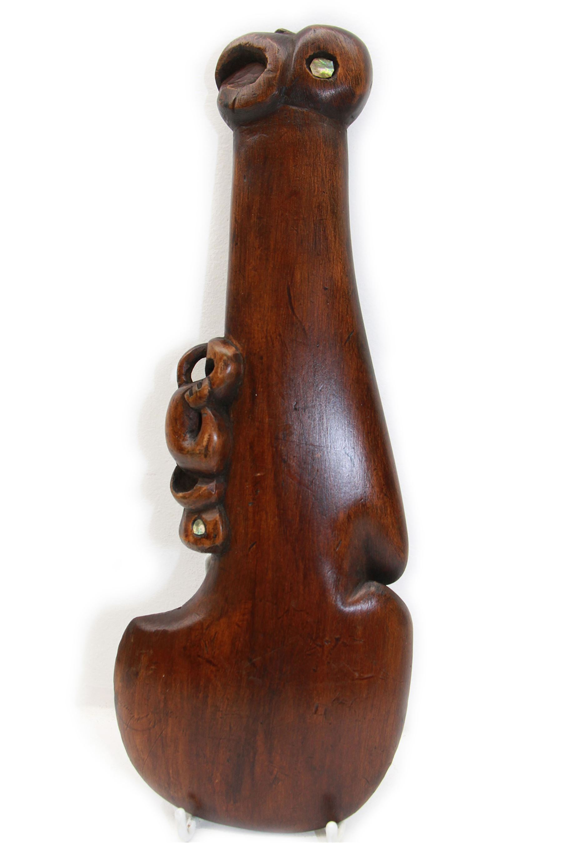 Maori hand club wahaika carved a tiki with inlaid shell eyes