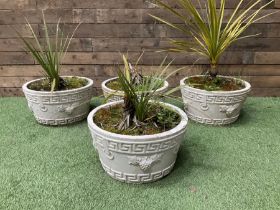 Four cast stone circular planters in white