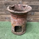 Terracotta garden burner decorated with grape vines