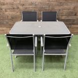 Rectangular metal framed garden table with glass top and four stackable chairs