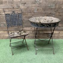 Circular metal garden table with tile top and matching chair