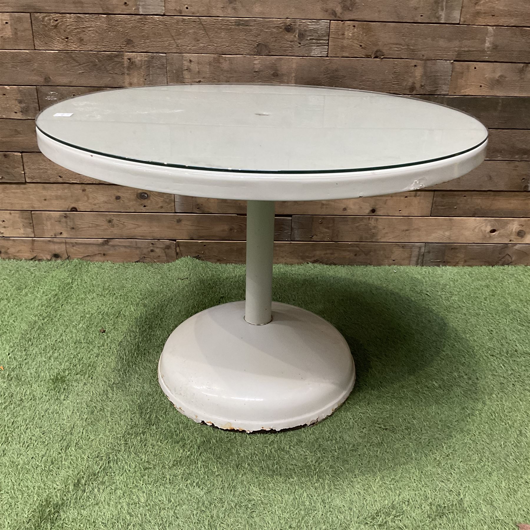 Circular white painted pedestal table with glass top