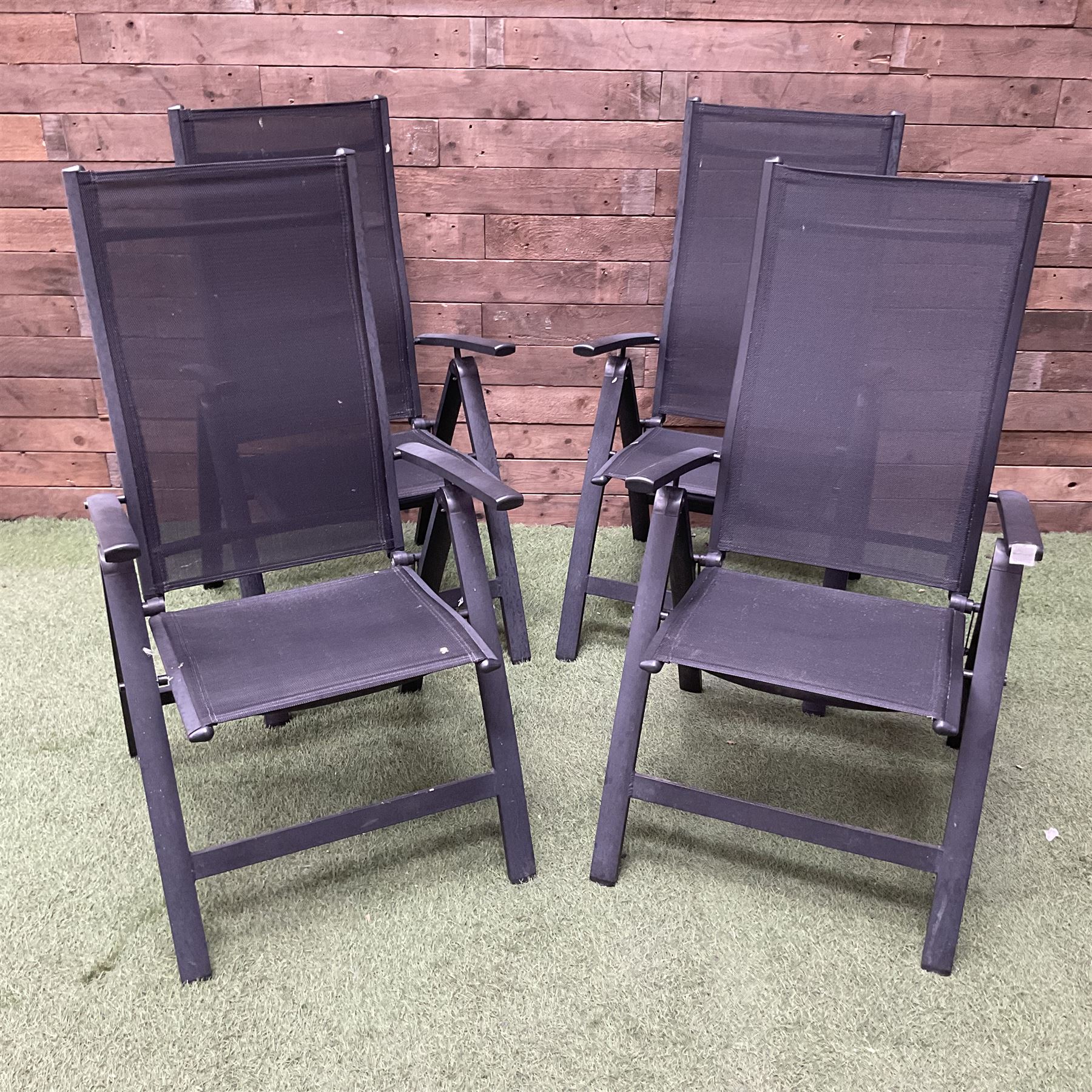 Four metal and mesh fabric folding garden chairs in black