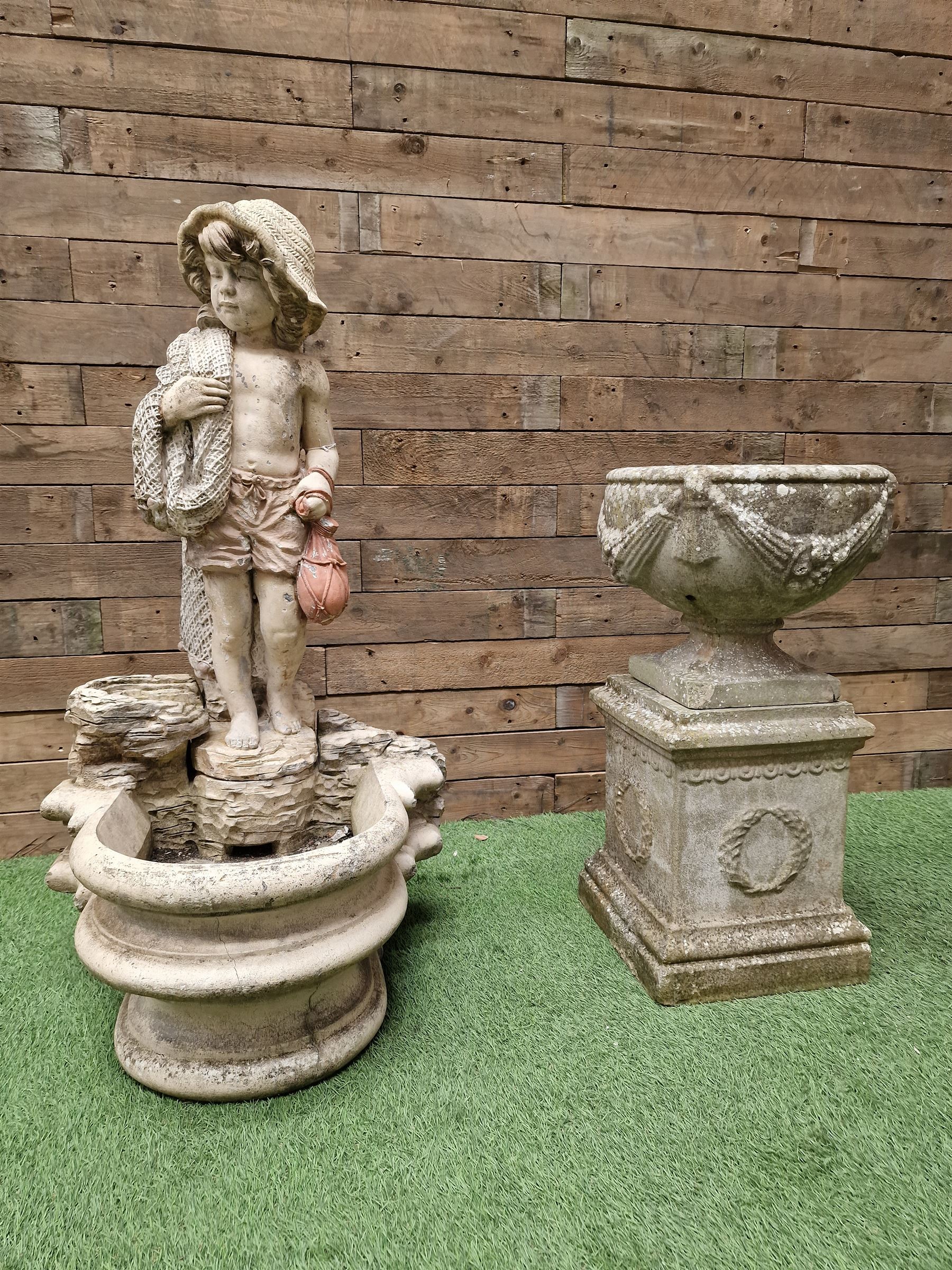 Three section cast stone garden figure of a boy carrying fishing net and a satchel with a water feat