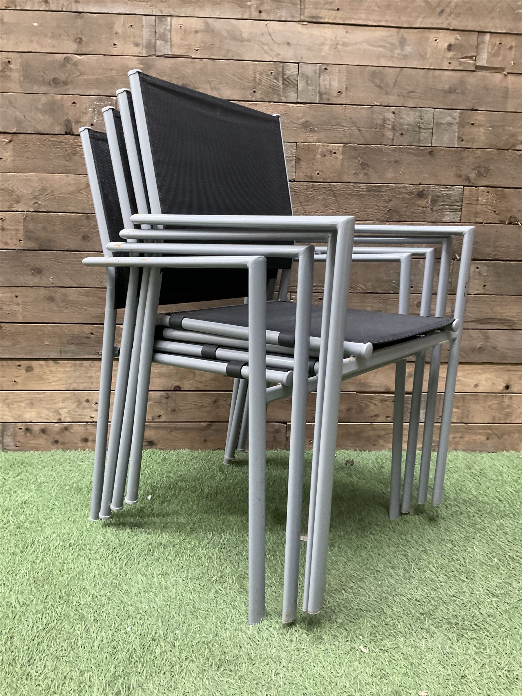 Rectangular metal framed garden table with glass top and four stackable chairs - Image 2 of 4