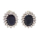 Pair of 14ct white gold oval cut sapphire and round brilliant cut diamond cluster stud earrings