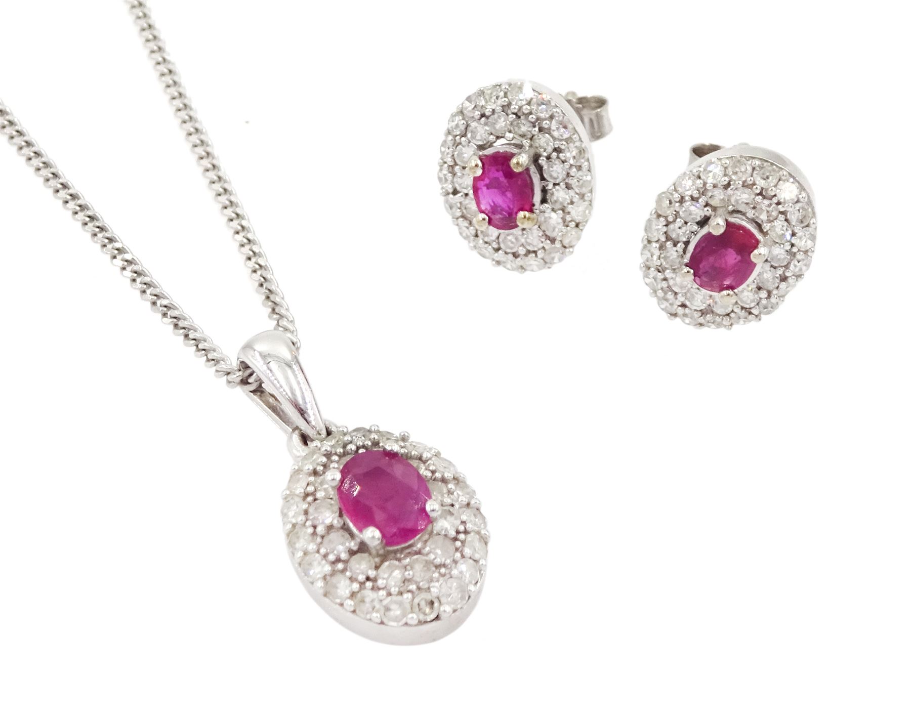 Pair of 9ct white gold oval cut ruby and round brilliant cut diamond cluster stud earrings and a mat