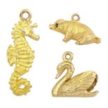Three 9ct gold pendant / charms including sitting pig