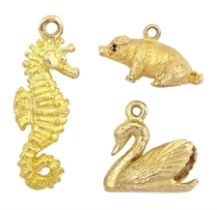 Three 9ct gold pendant / charms including sitting pig