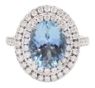 18ct white gold oval cut aquamarine and two row round brilliant cut diamond ring