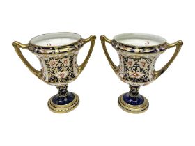 Pair of Royal Crown Derby 6299 Imari pattern twin handled trophy vases