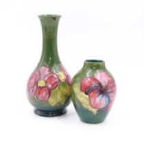 Two small Moorcroft vases decorated in the Anemone and Hibiscus on green grounds