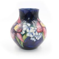 Moorcroft vase of squat baluster form in Orchid pattern H14cm