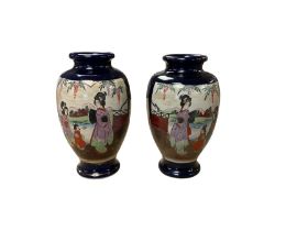 Pair of Japanese vases decorated with figures in a landscape