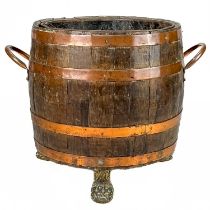 A copper bound oak barrel form log bin.