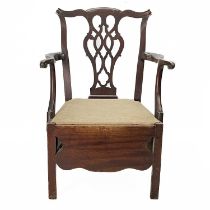 A George III provincial mahogany commode chair.