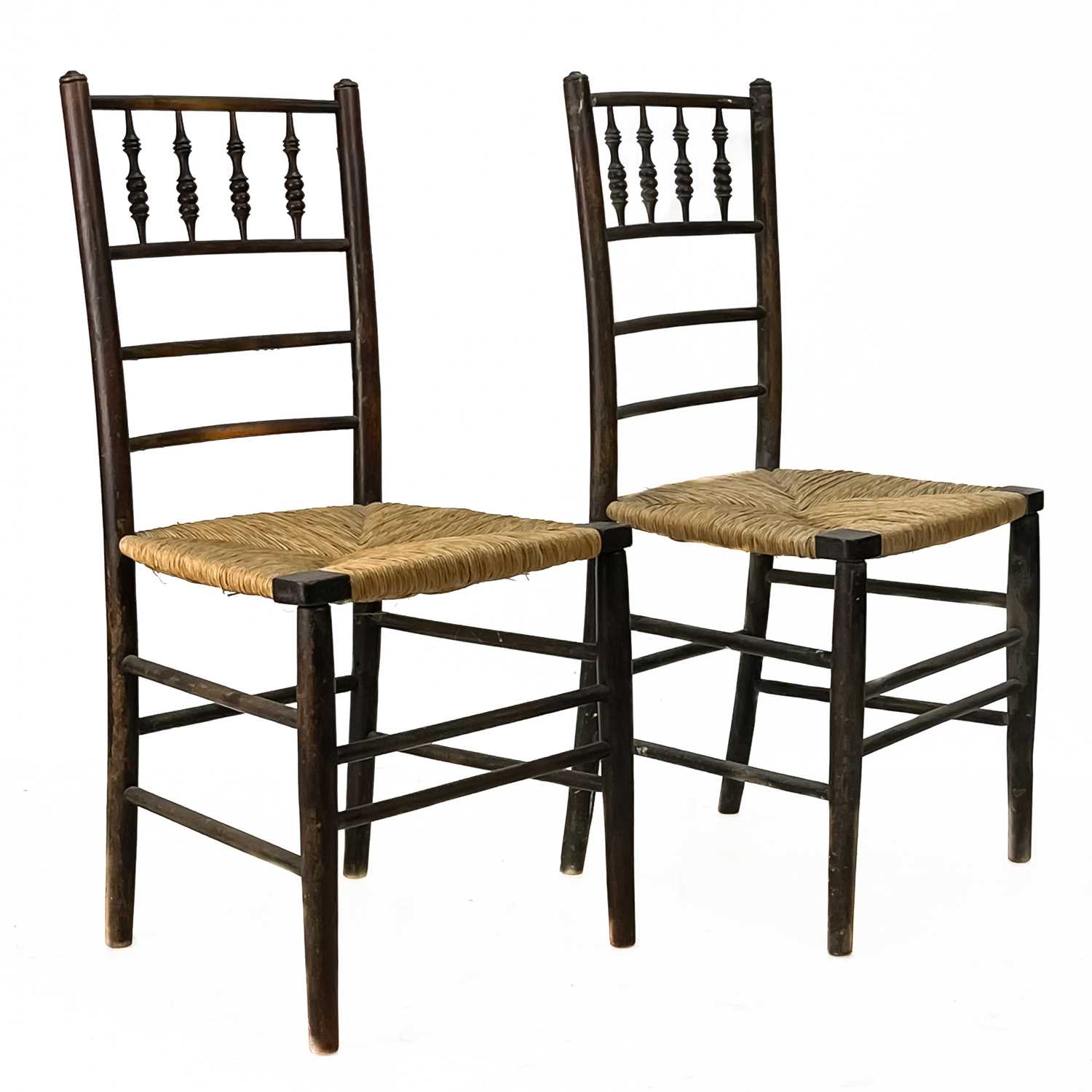 A pair of spindle back rush seat chairs.