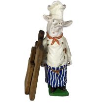 A painted plaster figure of a pig.