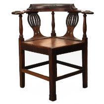 A late George III fruitwood corner chair.