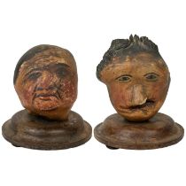 A pair of folk art 'hedgerow' carved treen and painted heads.
