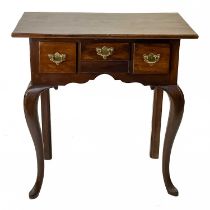 A George III walnut and oak lowboy.