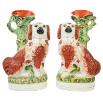 A pair of Victorian Staffordshire pottery spaniel spill vases.