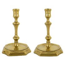 A pair of Georgian cast brass candlesticks.