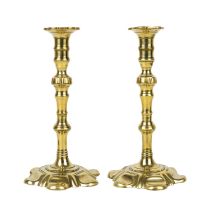 A pair of George III brass candleholders with petal bases.